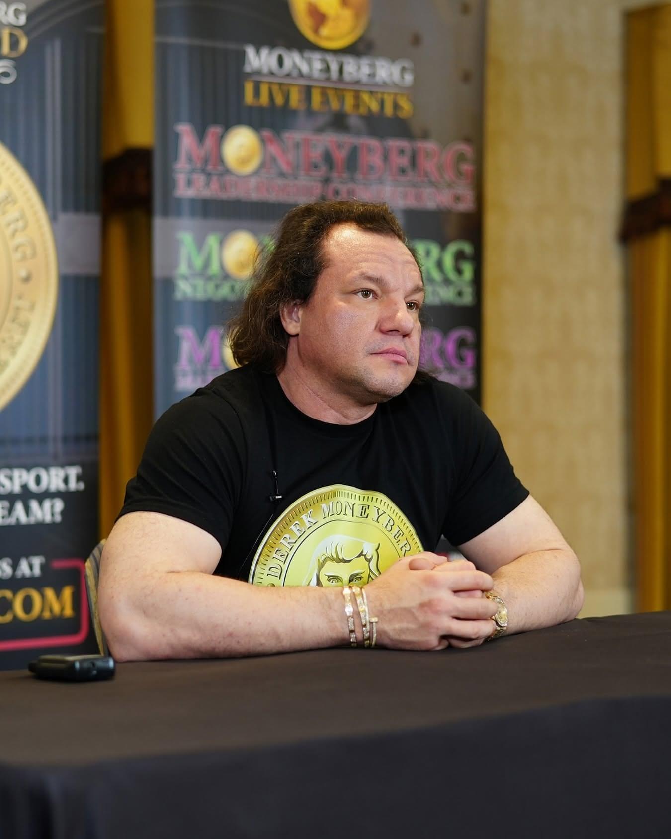 Derek Moneyberg seated at a table